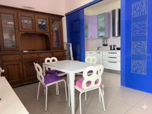 a kitchen with a white table and two chairs at Corso79 in Porto Santo Stefano +11 photos