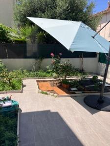 a white umbrella sitting on a patio at La Catalane in Perpignan