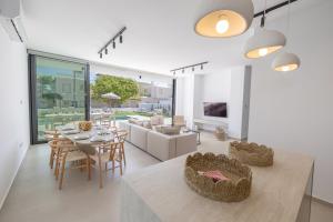 a kitchen and living room with a table and chairs at Ocean Whispers Villas in Paralimni