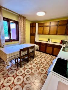 a kitchen with a table in the middle of a room at The Yugo House in Bohinj