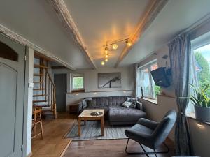 a living room with a couch and a table at Vila Preiloja - Cottages in Neringa