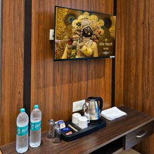 a picture of a deity on a wall above a table at Hotel Aroma in Mathura