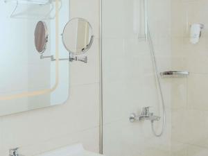 a bathroom with a shower with a mirror and a sink at ibis Styles Istanbul Bomonti in Istanbul +157 photos
