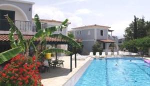 a large swimming pool in front of a house at Portego in Laganas