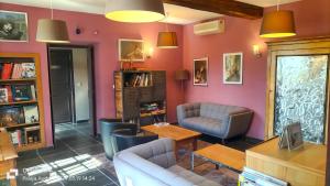 a living room with a couch and a table at Logis Hôtel Château De Palaja in Carcassonne
