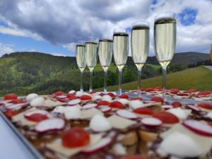 a group of wine glasses and appetizers on a table at Raj pod Košenjakom in Dravograd