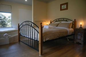 a bedroom with a large bed and a window at #2 Walpole Wilderness Resort chalet. Spa + forest. in Walpole