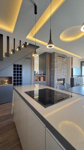 a kitchen with a large island with a counter top at NEVO FAQRA Elevate Your Stay! in Ḩaqlat as Sayyid