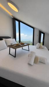 a large white bed with a table on top of it at NEVO FAQRA Elevate Your Stay! in Ḩaqlat as Sayyid +40 photos