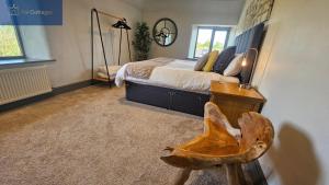 a bedroom with a bed and a wooden chair at Karadow in Saint Just in Roseland