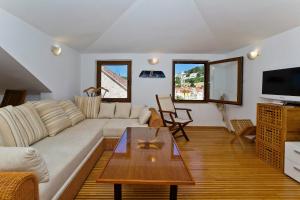 a living room with a couch and a coffee table at Apartment Plaza in Hvar