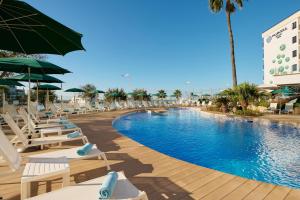 a pool at a resort with chairs and umbrellas at AluaSoul Palma Hotel Adults Only in Can Pastilla +73 photos