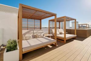a deck with two beds and a gazebo at AluaSoul Palma Hotel Adults Only in Can Pastilla