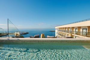 a swimming pool with a view of the ocean at AluaSoul Palma Hotel Adults Only in Can Pastilla