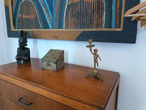 a wooden toy on top of a dresser with a box at La Maison des Artistes in Essaouira