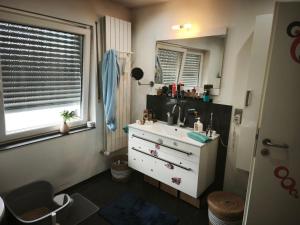a bathroom with a sink and a mirror at Appartement Klimaanlage WC in Mönchengladbach +13 photos