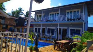 a house with a swimming pool in front of it at Sabbia Rossa Beach Resort in Arambol