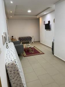 a living room with a couch and a table at Dar Frdj in Sousse