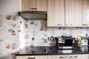 a kitchen with a wall with drawings on it at Jetadrenaline Watersports Club in Rewa