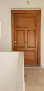 a wooden door in a room with a wooden floor at Dar Frdj in Sousse
