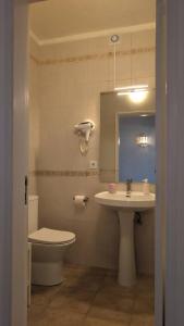 a bathroom with a toilet and a sink at 1D Albufeiras Baysight flat in Albufeira +25 photos