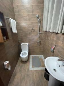 a bathroom with a toilet and a sink at KIGALI FANTASTIC Aparthotel in Kigali