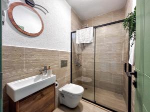 a bathroom with a toilet and a sink and a mirror at Mlinova Küçükköy in Ayvalık +95 photos