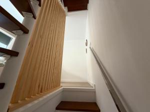 a staircase with wooden railings in a building at Casa Caracol in Cambados