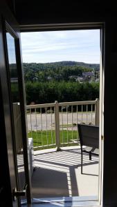 an open door to a balcony with a bench at Condo St Sauveur in Piedmont