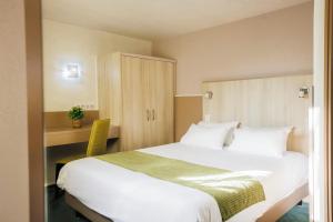 a hotel room with a large bed and a desk at Mont Vernon in Saint-Marcel +17 photos