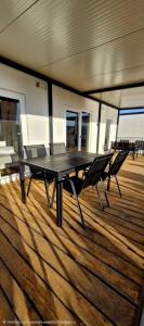 a table and two chairs on a deck of a boat at Mobile Homes Gasperino in Pirovac