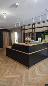 a lobby with a counter with flowers on it at Brido in Bardo