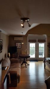 a living room with a couch and a table at Condo St Sauveur in Piedmont