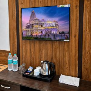 a hotel room with a picture of a building on the wall at Hotel Aroma in Mathura