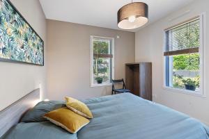 a bedroom with a blue bed with two pillows at Chambre - Le Nid in Saint-Prouant