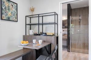a kitchen with a table with a bowl of oranges on it at Chambre - Le Nid in Saint-Prouant +9 photos