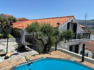 a villa with a swimming pool and a house at Segredos da Montanha - Seia in Seia