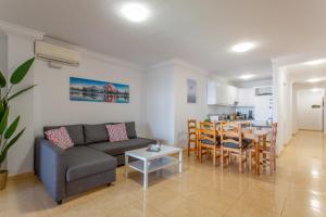 a living room with a couch and a table at Ático en Candelaria 1 in Candelaria
