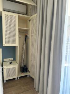 a bedroom with a curtain and a bed with at terrace kaprovan in Urekis Sadguri