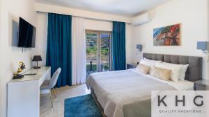 a bedroom with a king sized bed with blue curtains at Villa Guapa in Kardhakáta +54 photos