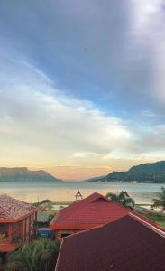 a view of a large body of water with buildings at Toba Village Inn in Tuktuk Siadong