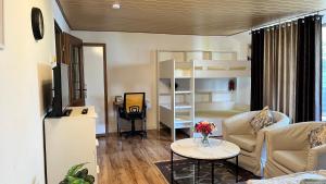 a living room with a couch and a table at Private Studio Apartment with Balcony in Dortmund-Brackel in Dortmund
