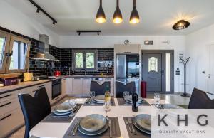 a kitchen with a table and chairs and a kitchen with a kitchen at Villa Guapa in Kardhakáta