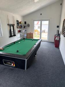 a billiard room with a pool table in it at Petrovf Place in Daljan