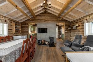 a living room with a fireplace and wooden walls at Unique mountain retreat in Gol in Gol