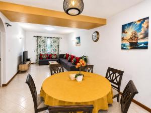 a living room with a table and a couch at Solrise Villa in Palmar