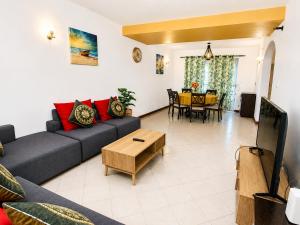 a living room with a couch and a table at Solrise Villa in Palmar