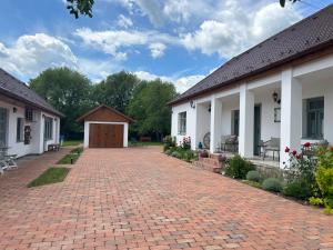 a brick driveway in front of a building at Relaxxa Apartman in Noszvaj