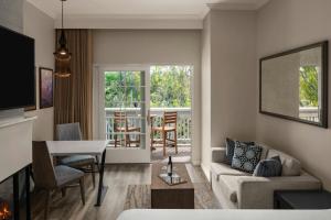 a living room with a couch and a table at River Terrace Inn in Napa