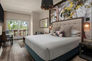 a bedroom with a large bed and a desk at River Terrace Inn in Napa +41 photos